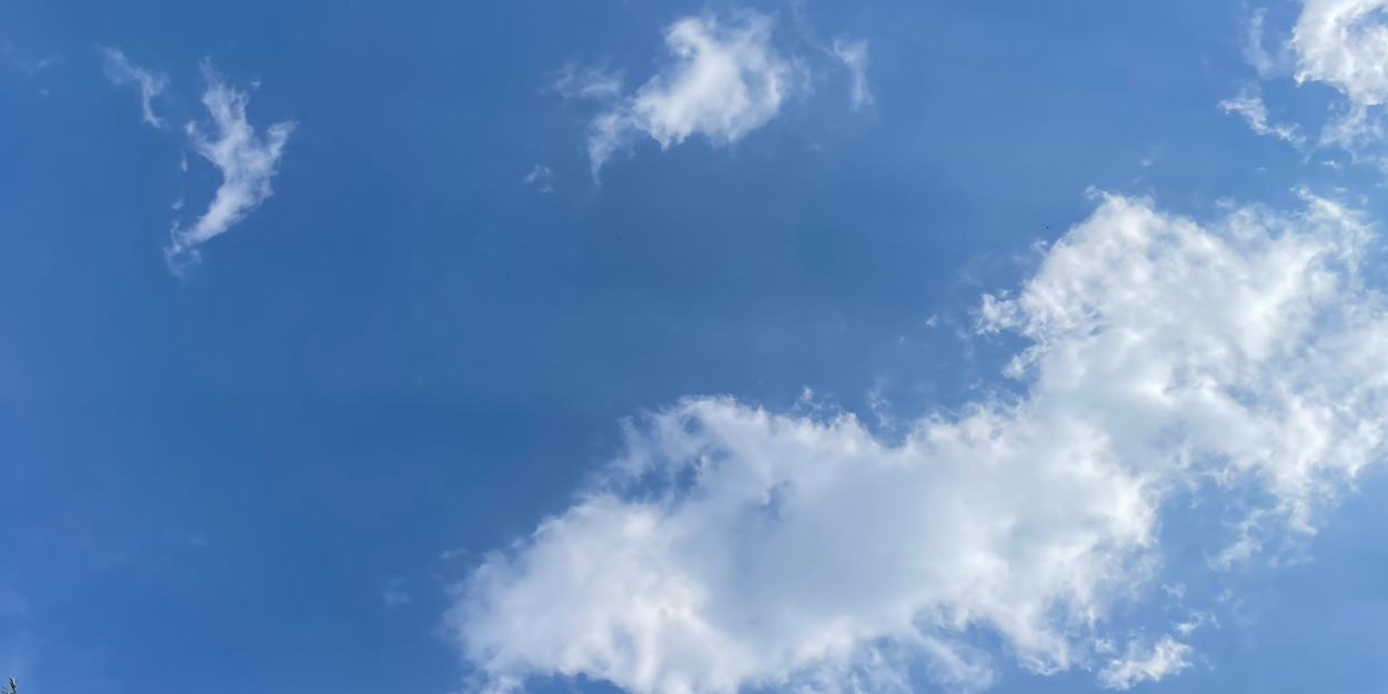 Wispy and puffy clouds against a blue sky