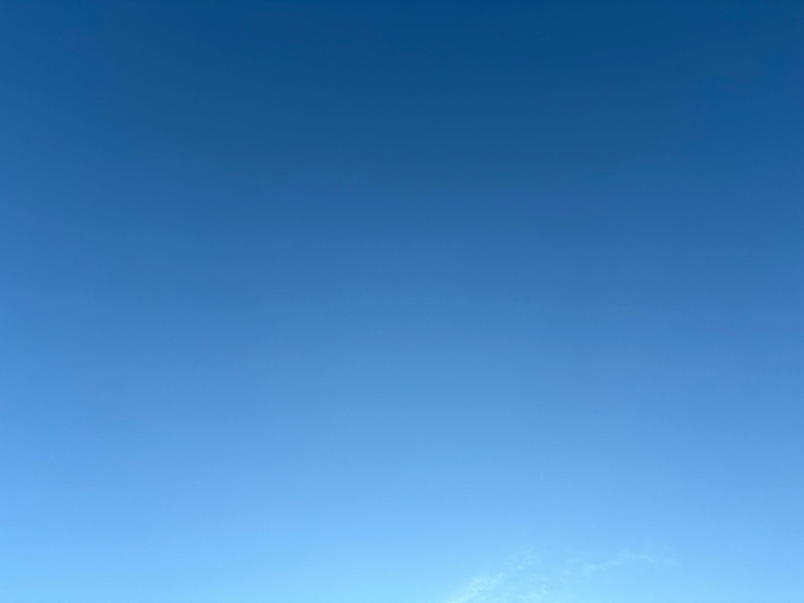 Blue sky with wispy cirrus clouds at bottom